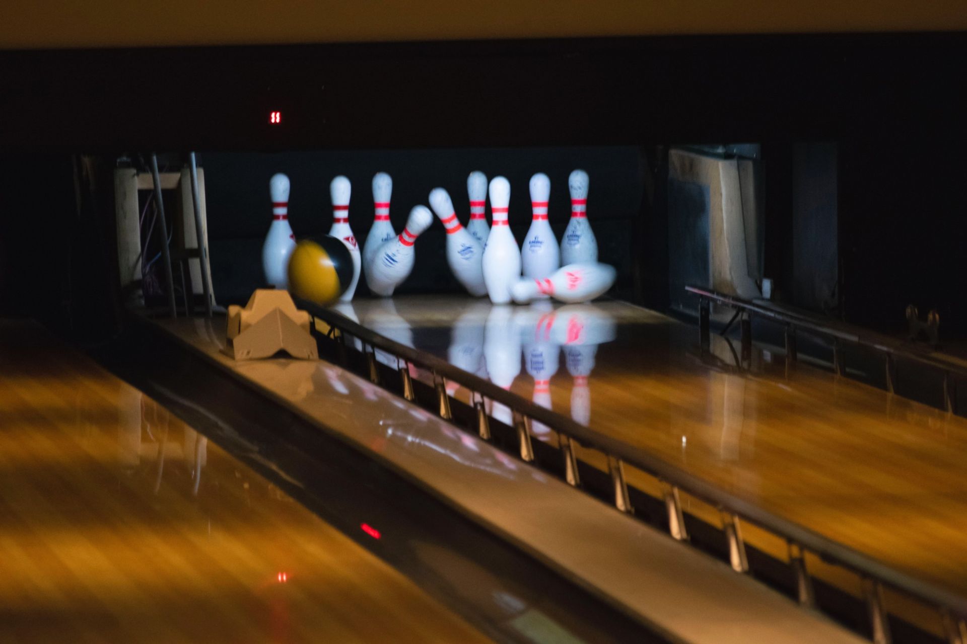 Bowling Alley skittles being knocked over.